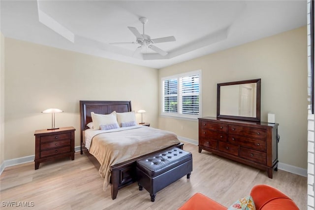 9102 Limestone Ln, Naples, FL 34120 - bedroom featuring ceiling fan, light wood-style floors, baseboards, and a raised ceiling