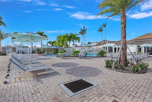 9102 Limestone Ln, Naples, FL 34120 - view of community featuring a swimming pool, a patio, and a residential view