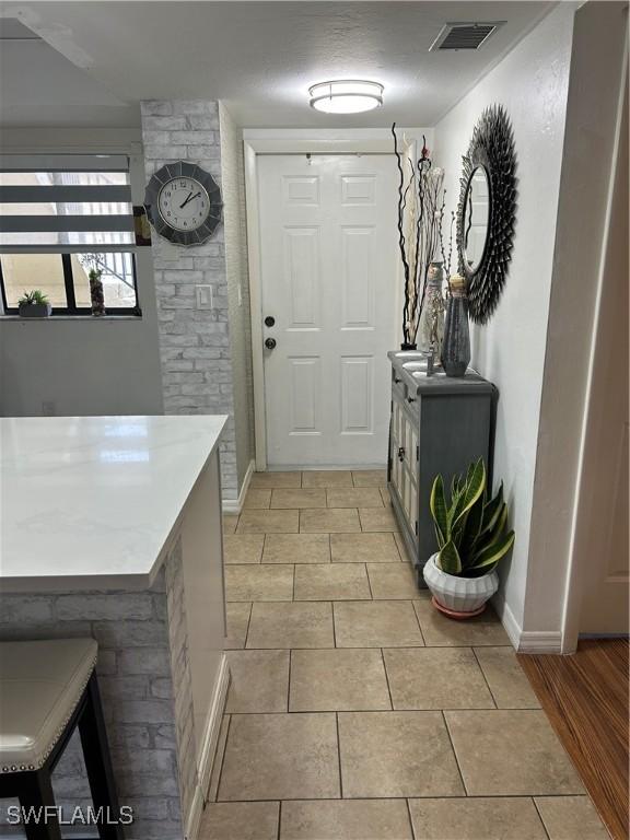 entryway featuring baseboards and visible vents