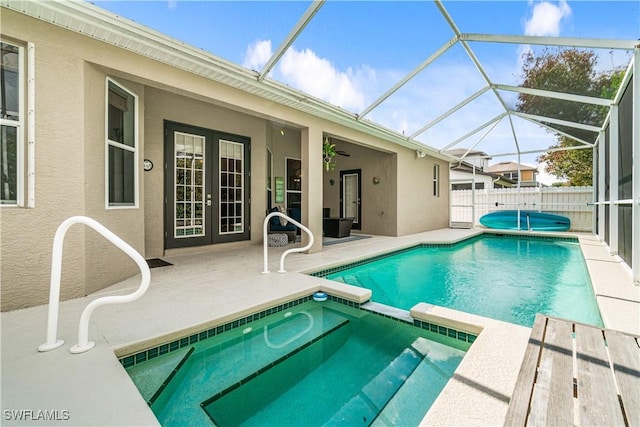 167 Burnt Pine Dr, Naples, FL 34119 - view of pool featuring french doors, a lanai, fence, a pool with connected hot tub, and a patio