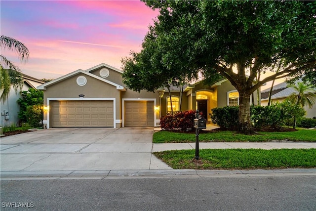 167 Burnt Pine Dr, Naples, FL 34119 - view of front of property with an attached garage, driveway, and stucco siding