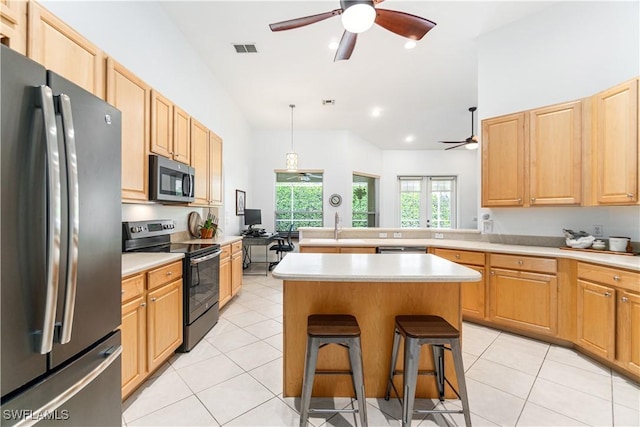 167 Burnt Pine Dr, Naples, FL 34119 - kitchen featuring light countertops, visible vents, a kitchen bar, appliances with stainless steel finishes, and ceiling fan