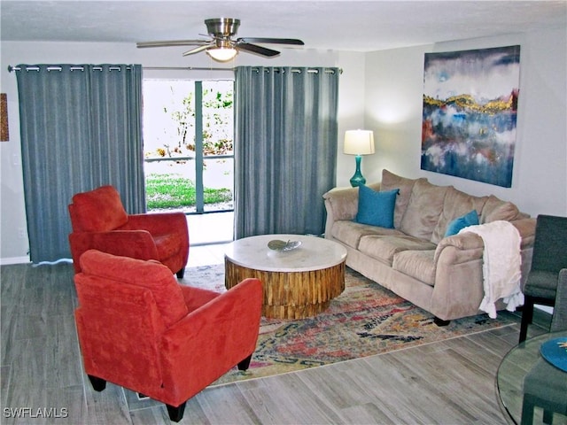 living room with wood finished floors and a ceiling fan
