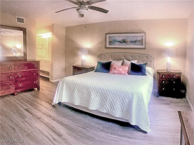 bedroom featuring ceiling fan, baseboards, wood finished floors, and visible vents