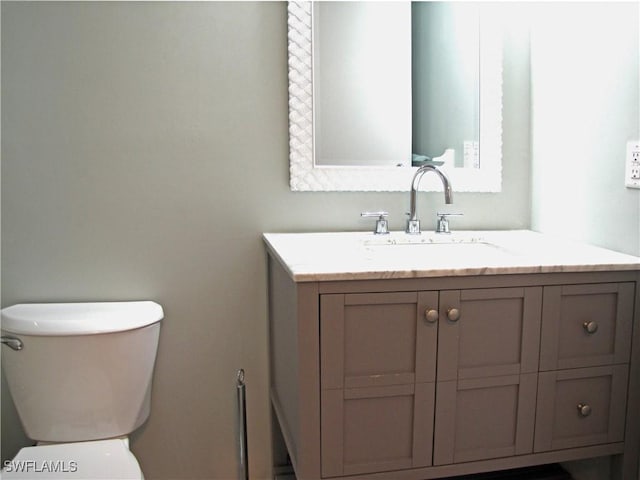 bathroom with toilet and vanity