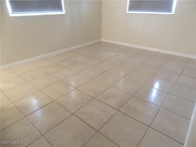 18215 Iris Rd, Fort Myers, FL 33967 - spare room with light tile patterned flooring and baseboards