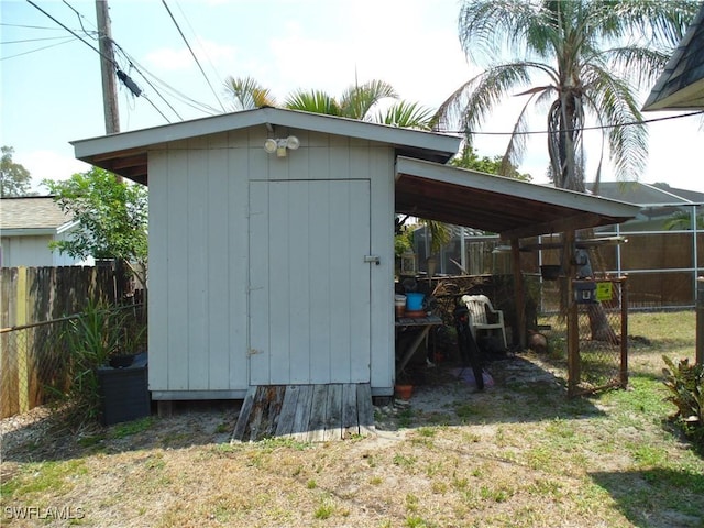18215 Iris Rd, Fort Myers, FL 33967 - view of shed featuring a fenced backyard and a carport