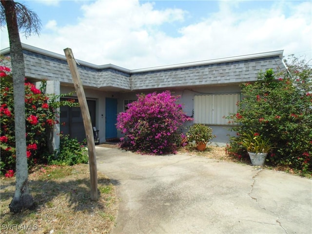 18215 Iris Rd, Fort Myers, FL 33967 - view of front of home with a shingled roof and mansard roof
