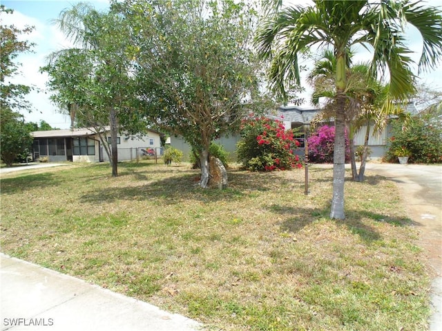 18215 Iris Rd, Fort Myers, FL 33967 - view of front facade with a front lawn and a sunroom