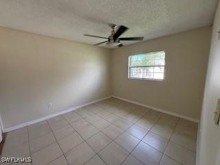 18215 Iris Rd, Fort Myers, FL 33967 - empty room featuring ceiling fan, light tile patterned flooring, and a textured ceiling