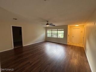 18215 Iris Rd, Fort Myers, FL 33967 - unfurnished living room with a ceiling fan and dark wood-style flooring