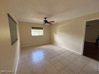 18215 Iris Rd, Fort Myers, FL 33967 - spare room featuring ceiling fan and light tile patterned flooring