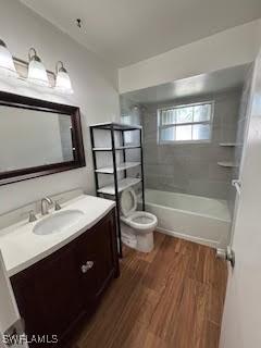 18215 Iris Rd, Fort Myers, FL 33967 - full bath with vanity, wood finished floors, and shower / bath combination