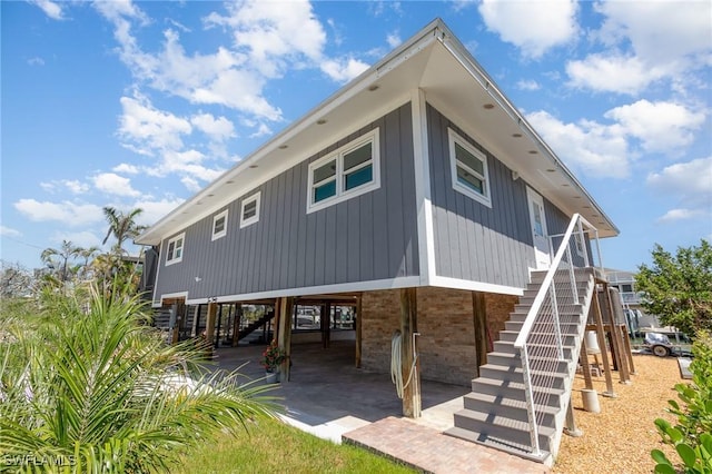 rear view of property with stairs