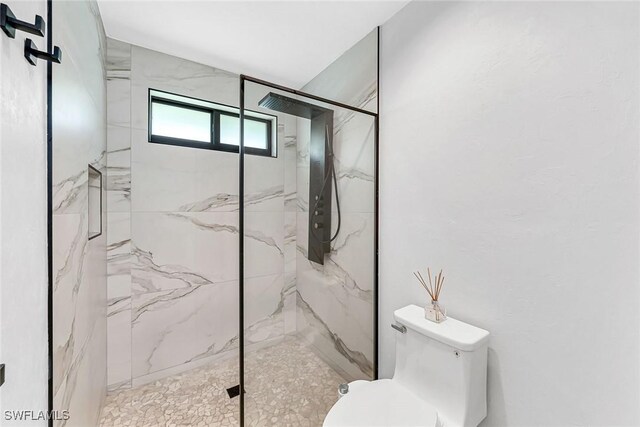 171 Palmetto Dunes Cir, Naples, FL 34113 - bathroom featuring toilet and a marble finish shower