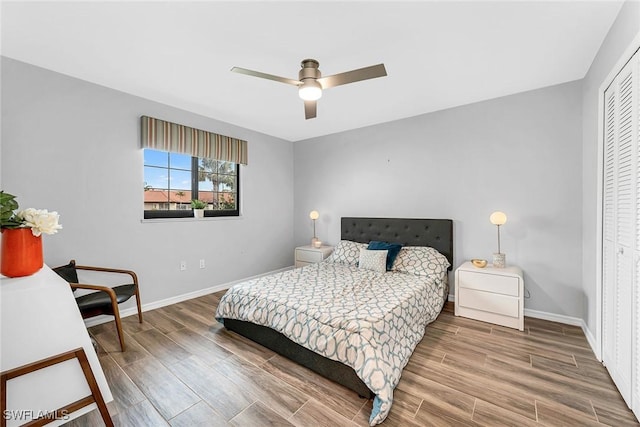 171 Palmetto Dunes Cir, Naples, FL 34113 - bedroom with baseboards, wood finished floors, a closet, and a ceiling fan