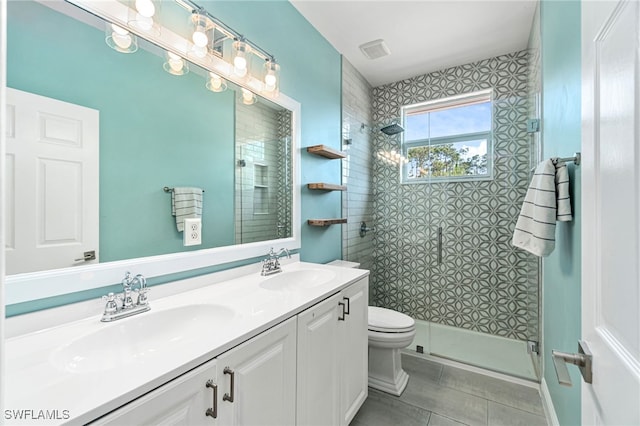bathroom with toilet, a shower stall, a sink, and tile patterned flooring