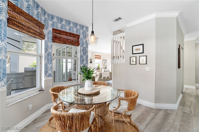 dining room featuring baseboards, a wealth of natural light, wood finished floors, and visible vents