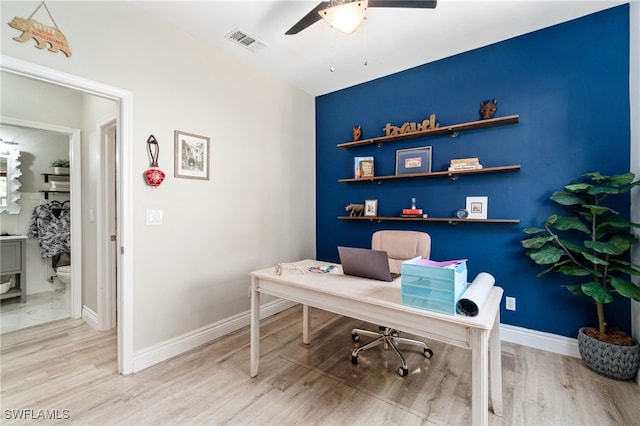 office area featuring baseboards, a ceiling fan, wood finished floors, and visible vents