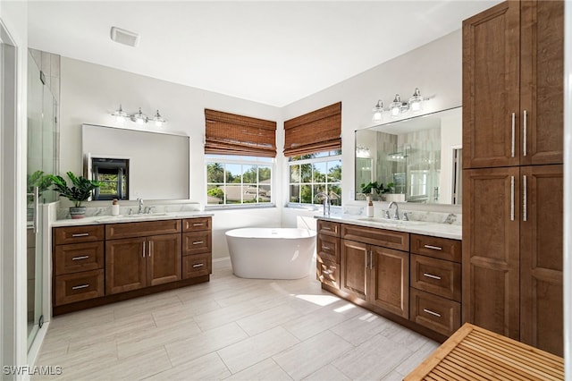 full bathroom with two vanities, a shower stall, and a sink
