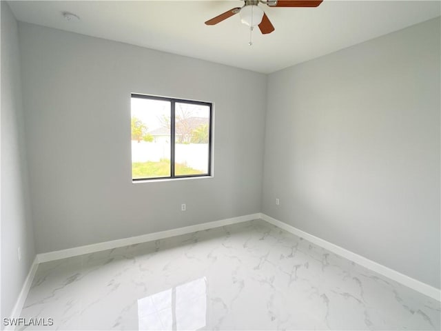 1103 Tropicana Pkwy W, Cape Coral, FL 33993 - unfurnished room featuring ceiling fan, marble finish floor, and baseboards