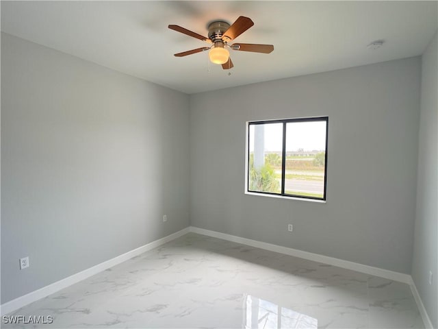 1103 Tropicana Pkwy W, Cape Coral, FL 33993 - empty room with baseboards, marble finish floor, and ceiling fan