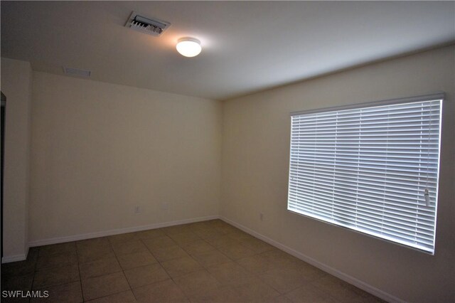 empty room featuring visible vents and baseboards