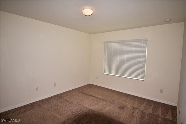 carpeted empty room with baseboards