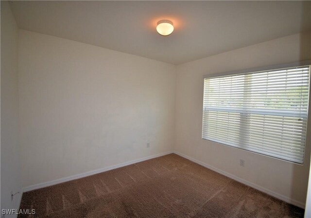spare room with carpet flooring and baseboards