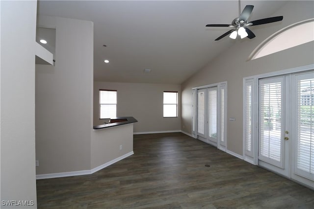 empty room with ceiling fan, vaulted ceiling, recessed lighting, dark wood-style flooring, and baseboards