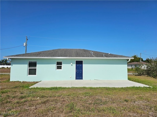7027 Palpano Cir, Labelle, FL 33935 - back of house featuring a patio area, a lawn, and stucco siding