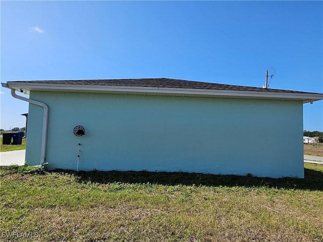 7027 Palpano Cir, Labelle, FL 33935 - view of side of home featuring a yard and stucco siding