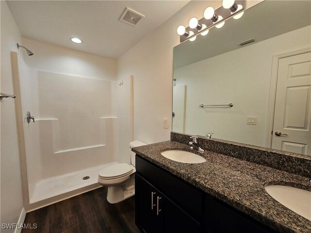 7027 Palpano Cir, Labelle, FL 33935 - full bathroom with toilet, wood finished floors, a sink, and visible vents