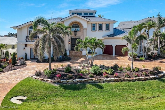 152 Conners Ave, Naples, FL 34108 - view of front of house with driveway, an attached garage, a front lawn, a standing seam roof, and metal roof