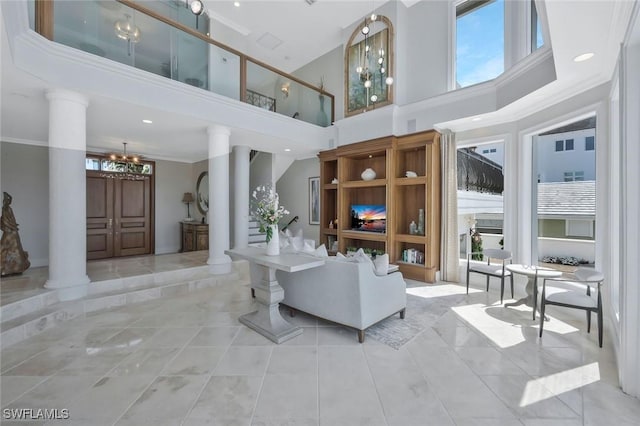 152 Conners Ave, Naples, FL 34108 - living area featuring tile patterned flooring, ornate columns, an inviting chandelier, and a high ceiling