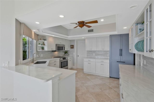 152 Conners Ave, Naples, FL 34108 - kitchen featuring open shelves, visible vents, appliances with stainless steel finishes, a sink, and a raised ceiling