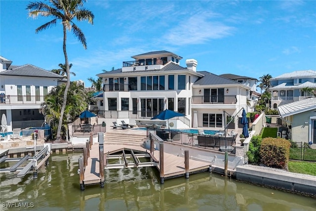 152 Conners Ave, Naples, FL 34108 - dock area featuring a water view, a patio area, boat lift, fence, and an outdoor pool