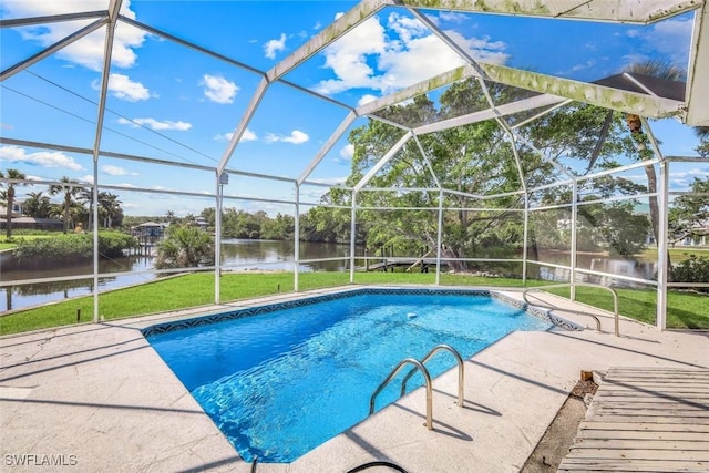 pool featuring a water view, glass enclosure, a lawn, and a patio area