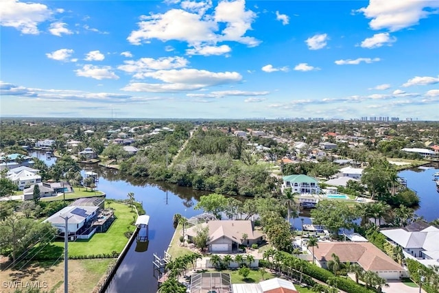 birds eye view of property with a water view and a residential view