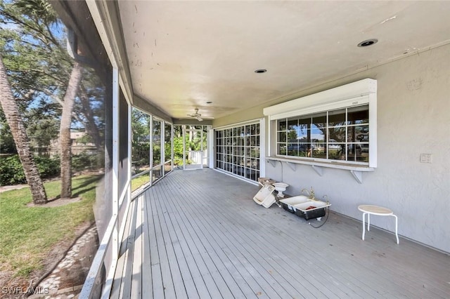 wooden deck with a ceiling fan