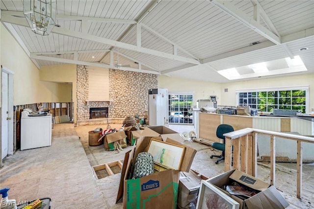 misc room with high vaulted ceiling, washer / clothes dryer, a fireplace, and visible vents