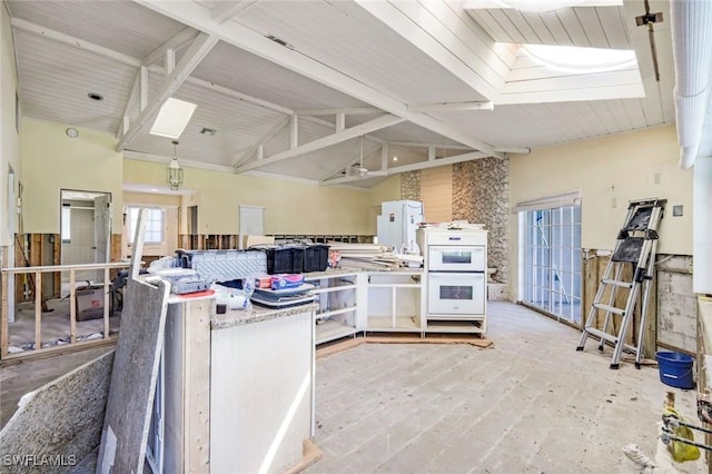 kitchen with a skylight and high vaulted ceiling