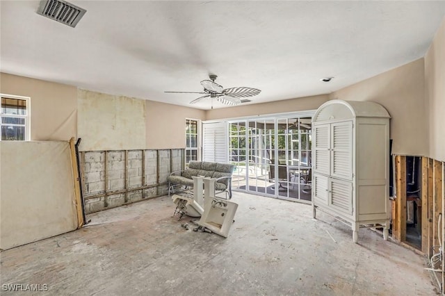 interior space with ceiling fan and visible vents
