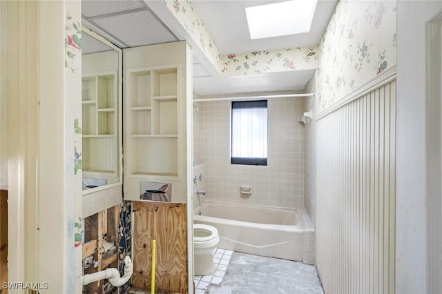 full bathroom featuring shower / bathing tub combination, wallpapered walls, toilet, and a skylight