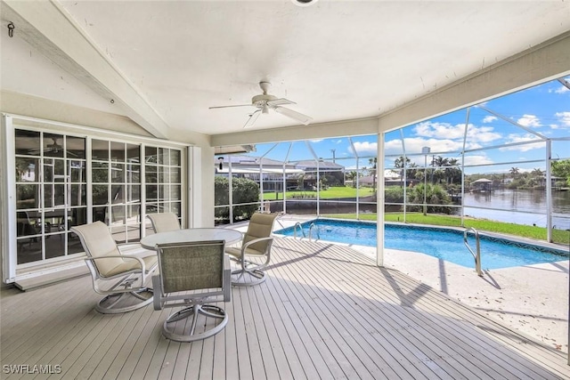 outdoor pool featuring a water view, a patio area, a ceiling fan, outdoor dining area, and a lanai