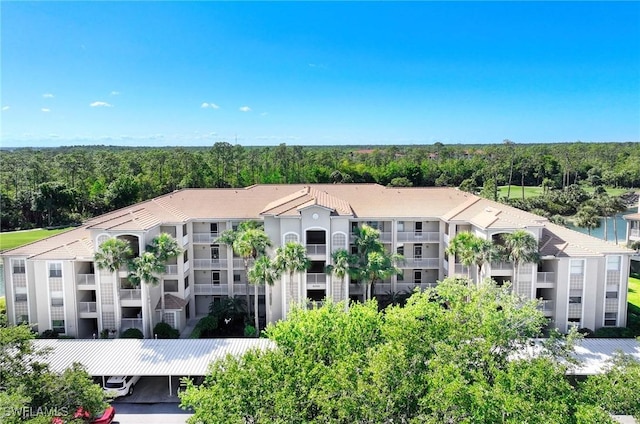 8680 Cedar Hammock Cir Unit 132, Naples, FL 34112 - view of apartment building / complex featuring a forest view