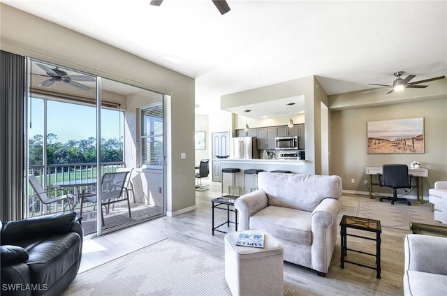 8680 Cedar Hammock Cir Unit 132, Naples, FL 34112 - living room with ceiling fan, light wood-style floors, and baseboards