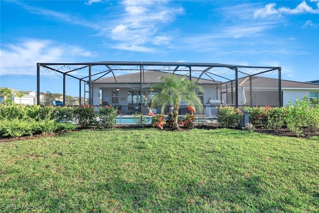 back of property featuring an outdoor pool, a yard, and glass enclosure