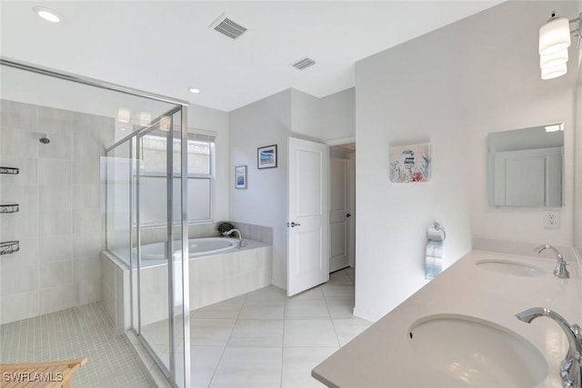 bathroom with a sink, visible vents, tile patterned floors, and a shower stall