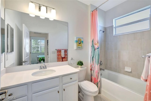full bathroom featuring toilet, vanity, shower / bath combo with shower curtain, and visible vents
